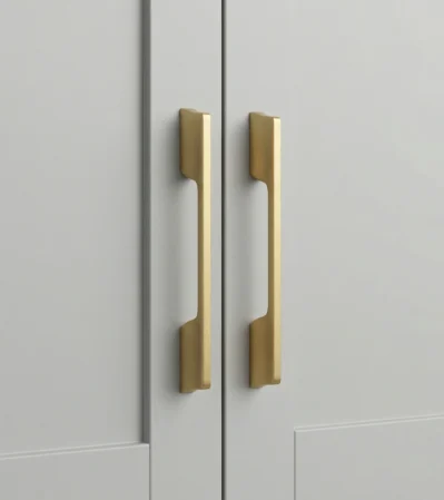 Brushed gold aluminum cabinet handle on grey cabinet door - minimalist bar pull hardware