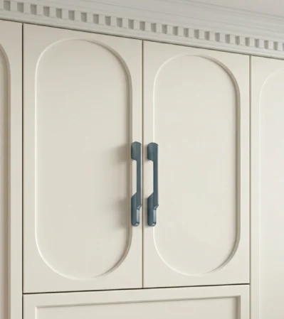 Slate blue aluminum cabinet handle on cream white cabinet door